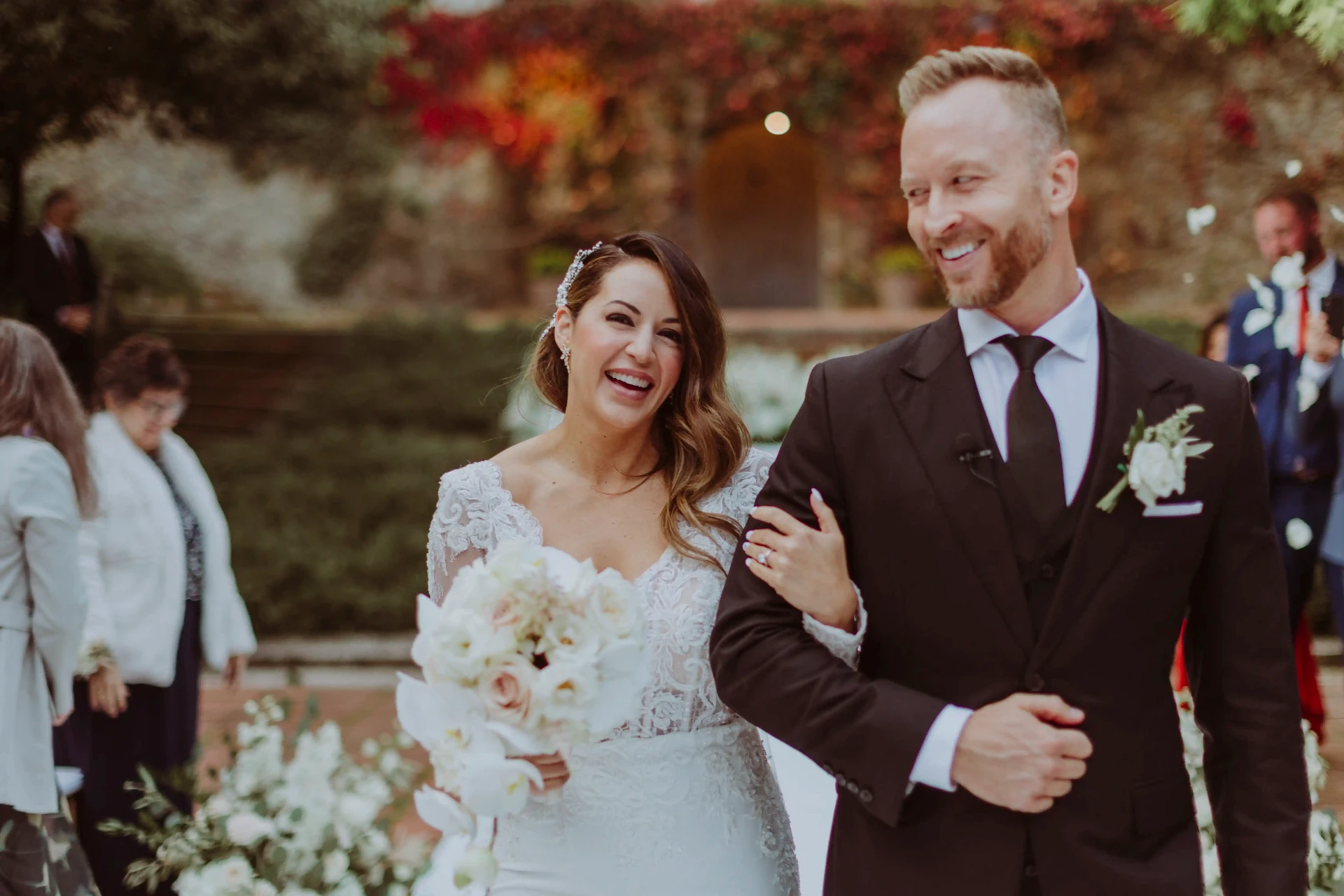 Lee y Ana riendo cogidos del brazo tras la ceremonia en Bell Recó, boda cerca de Barcelona