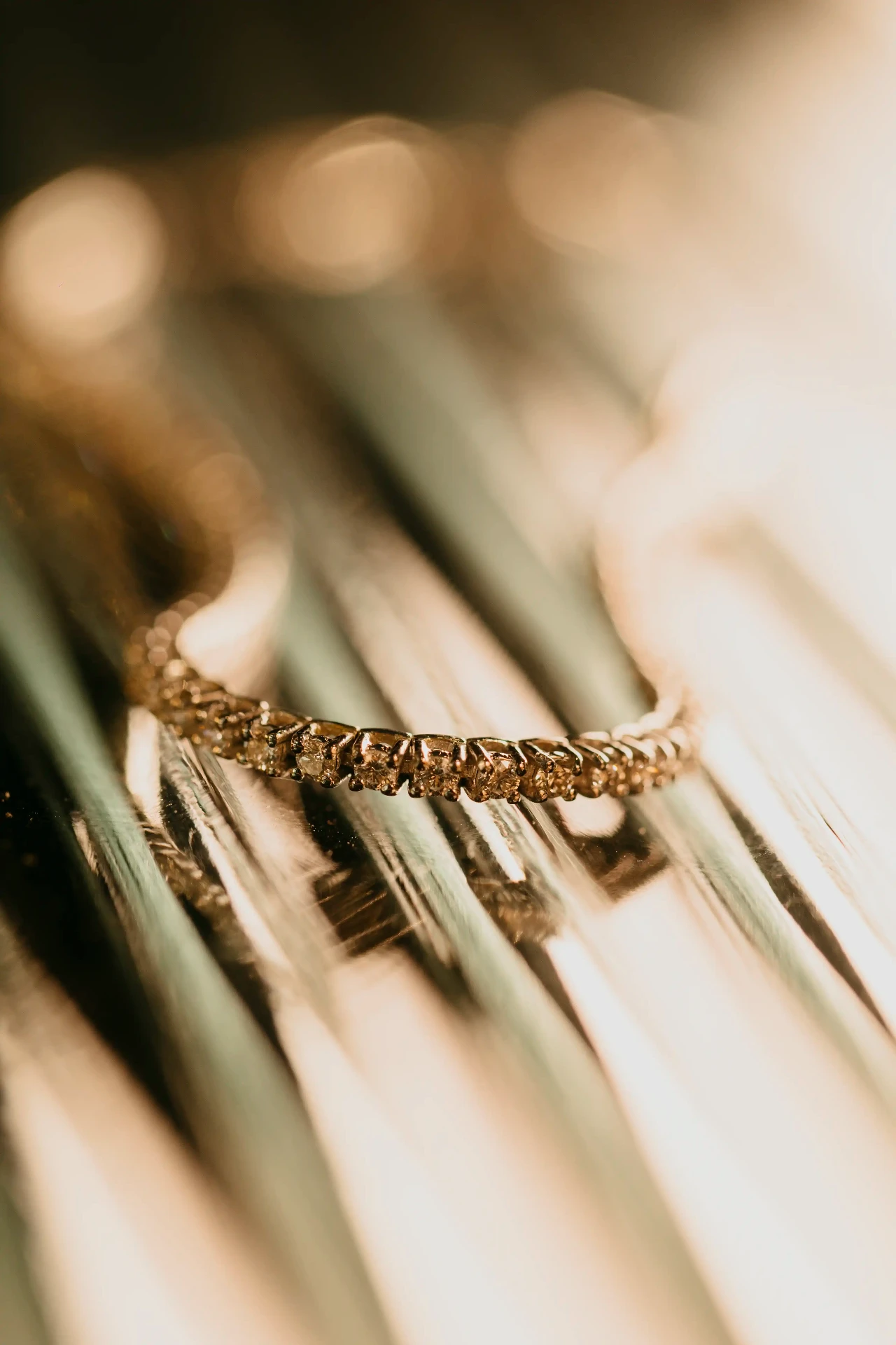 Detalle de pulsera de diamantes con luz cálida, fotografía de detalles boda La Boscana
