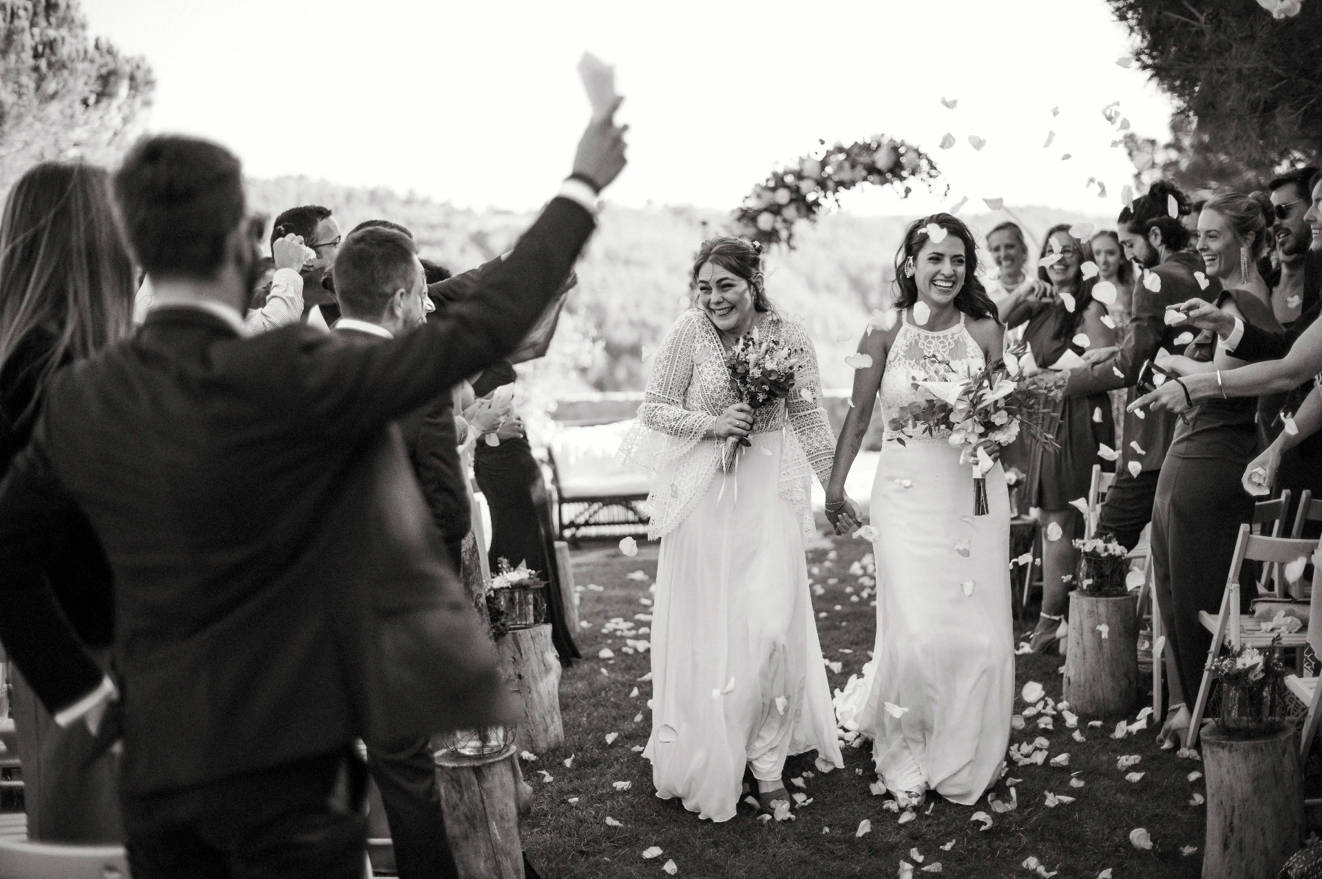 boda LGTBI en Ca n'Alzina — salida de las novias entre lluvia de pétalos y vítores de los invitados