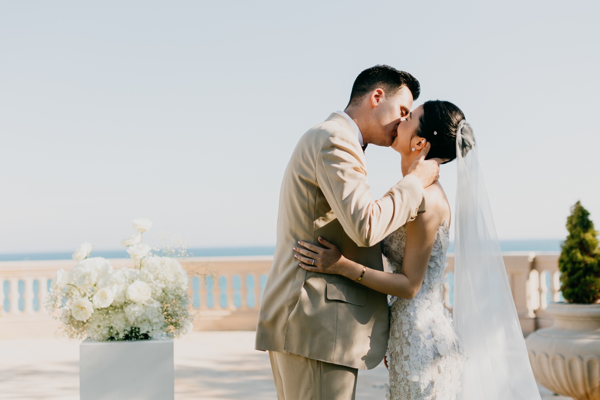 Cameron and Kara sharing their first kiss as married couple with sea views at Xalet del Nin
