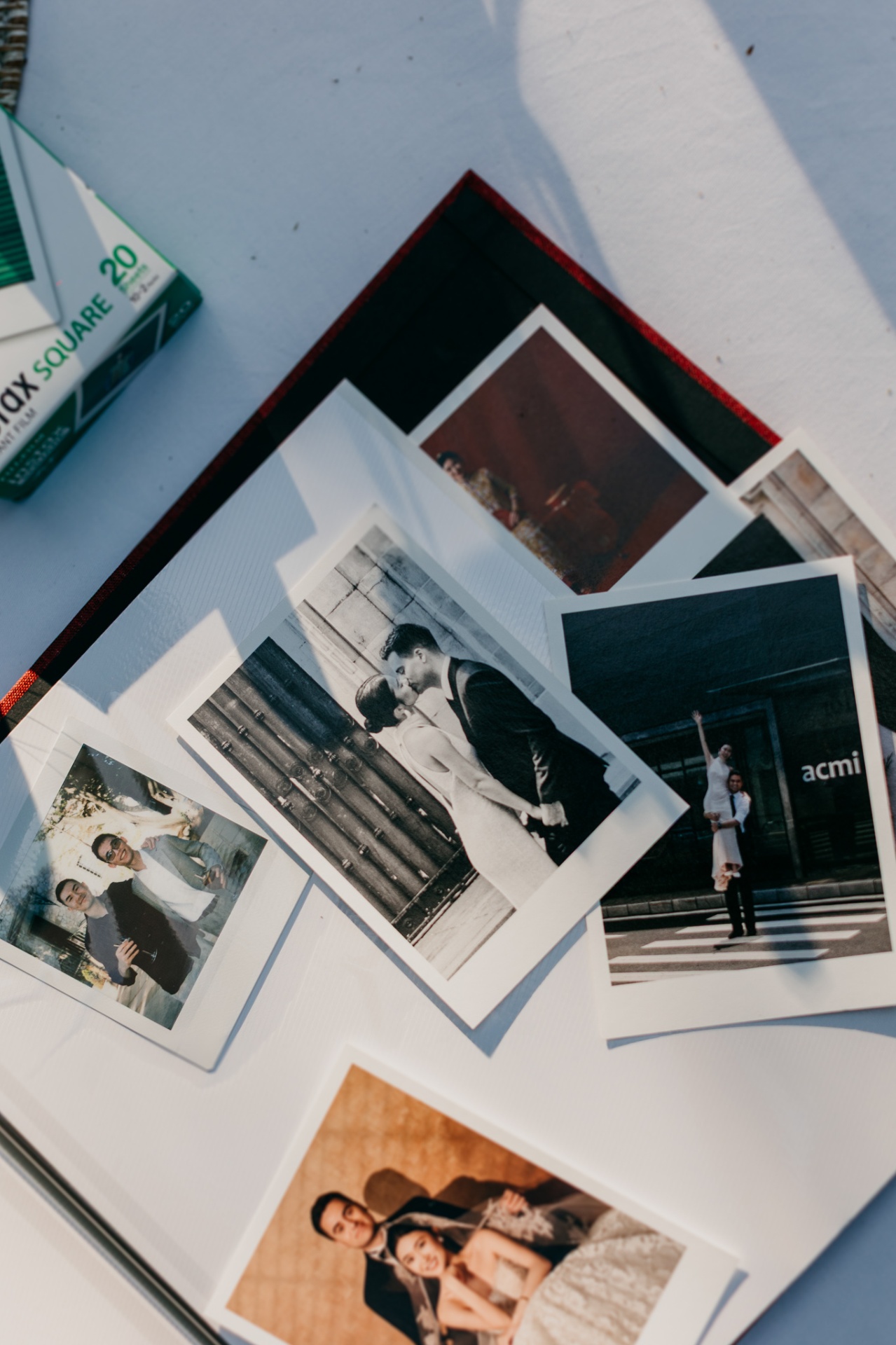 Instax polaroid photos scattered on a table as a wedding detail at Xalet del Nin