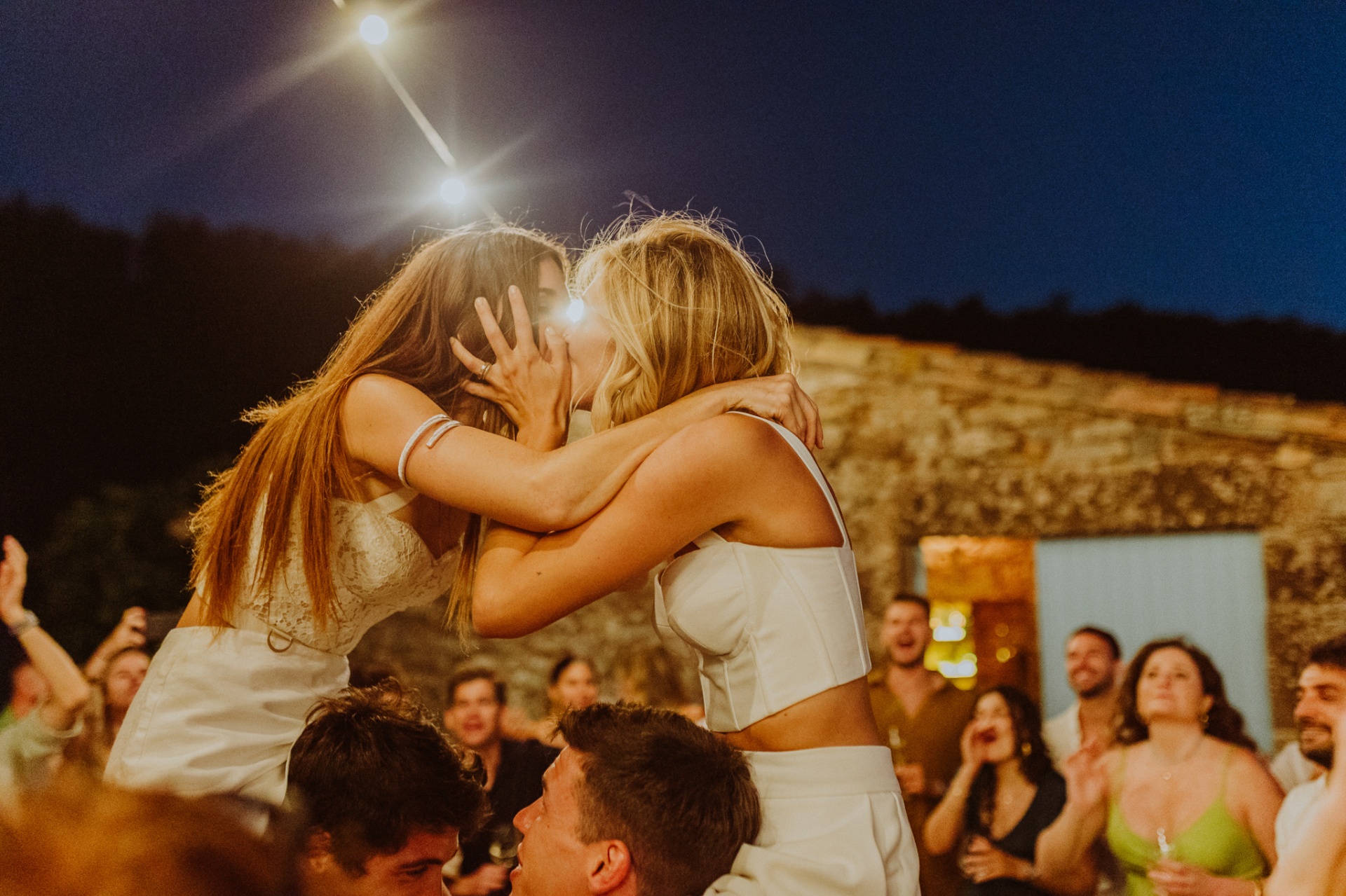 Chiara and Ro kissing passionately at night with guests cheering