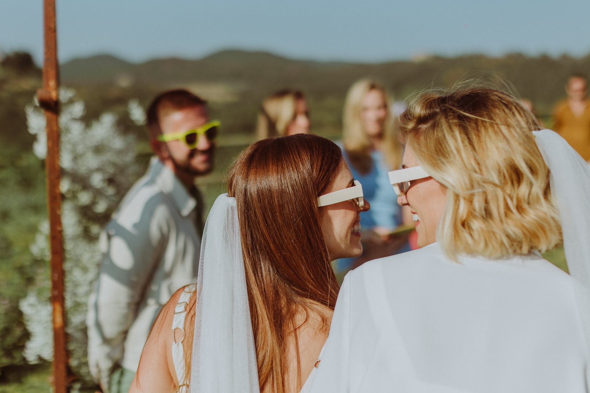Chiara and Ro wearing iconic white sunglasses during ceremony