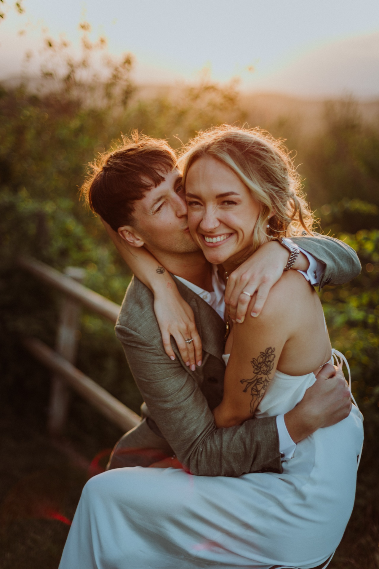 Conor kissing Ellie on the cheek in intimate embrace at sunset