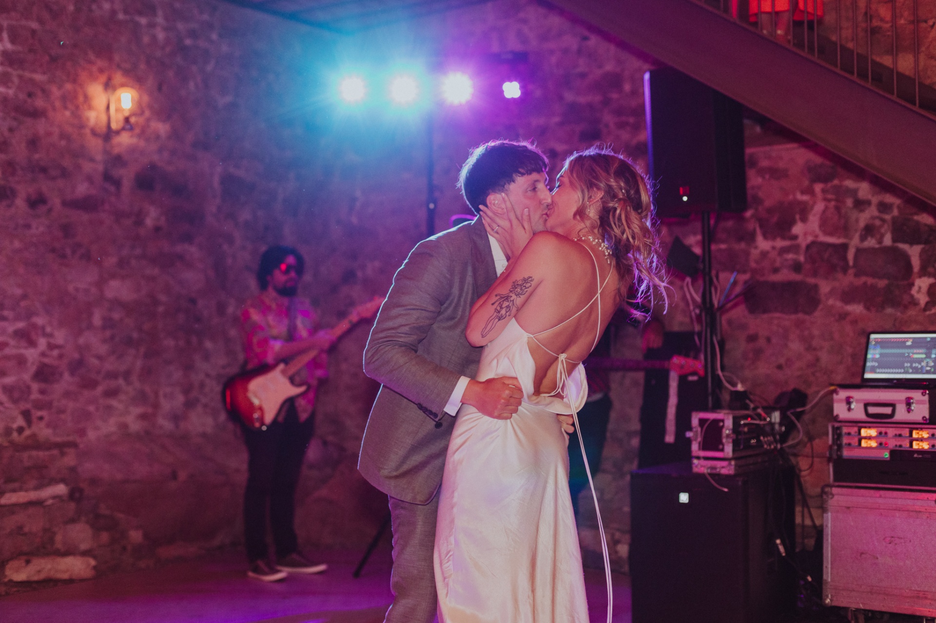 Ellie and Conor kissing on dance floor with live band and purple lights