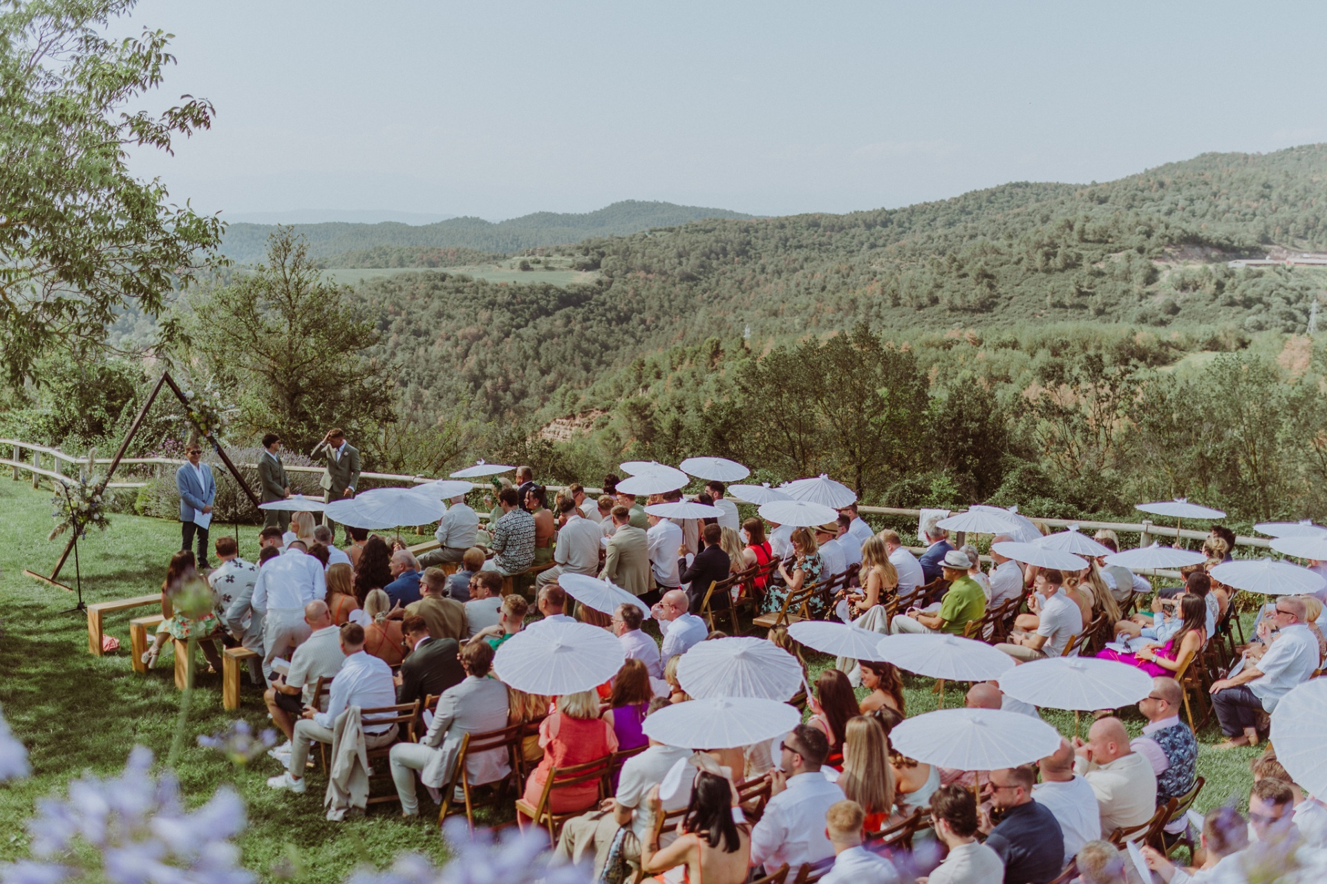 Outdoor ceremony with parasols and Moianès mountain views at TMBTP