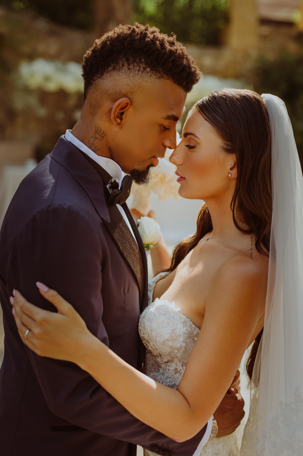 Intimate close-up of Laura and Jose touching foreheads at golden hour