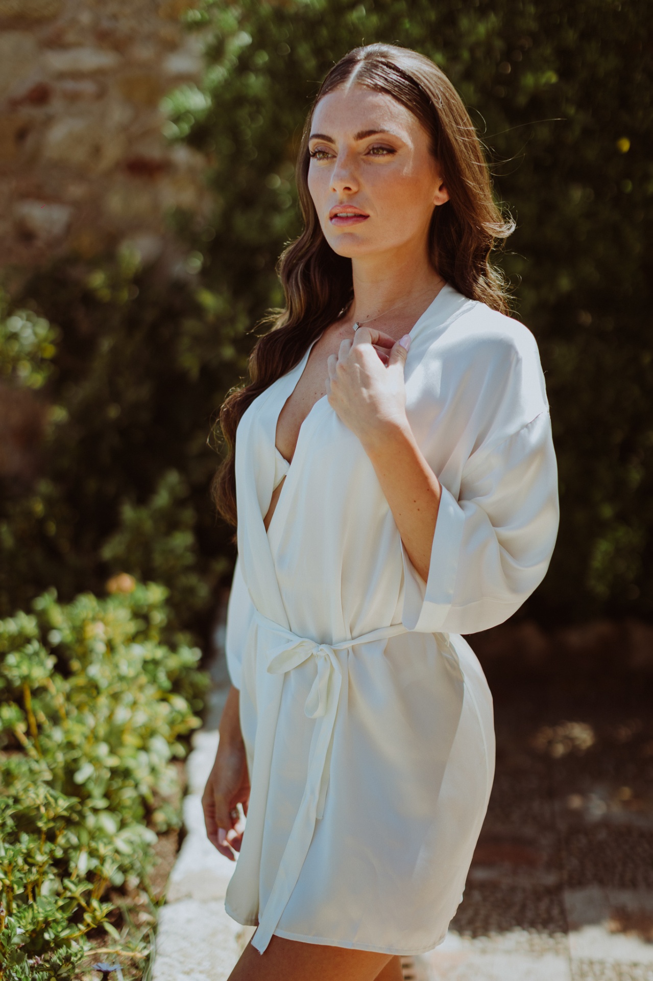 Laura in silk robe in the castle gardens before the ceremony
