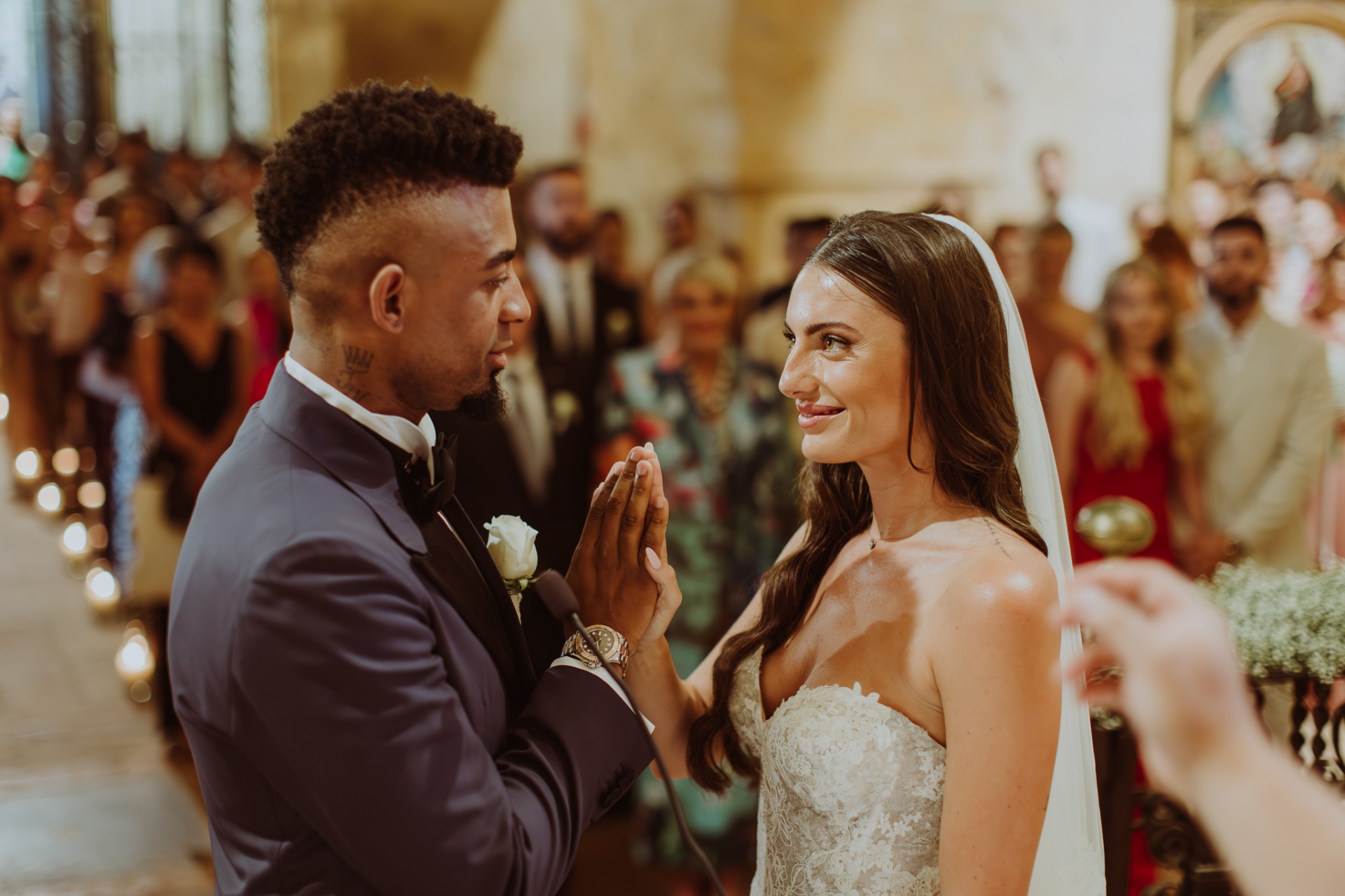 Laura and Jose holding hands and smiling during ceremony at Castell de Tamarit