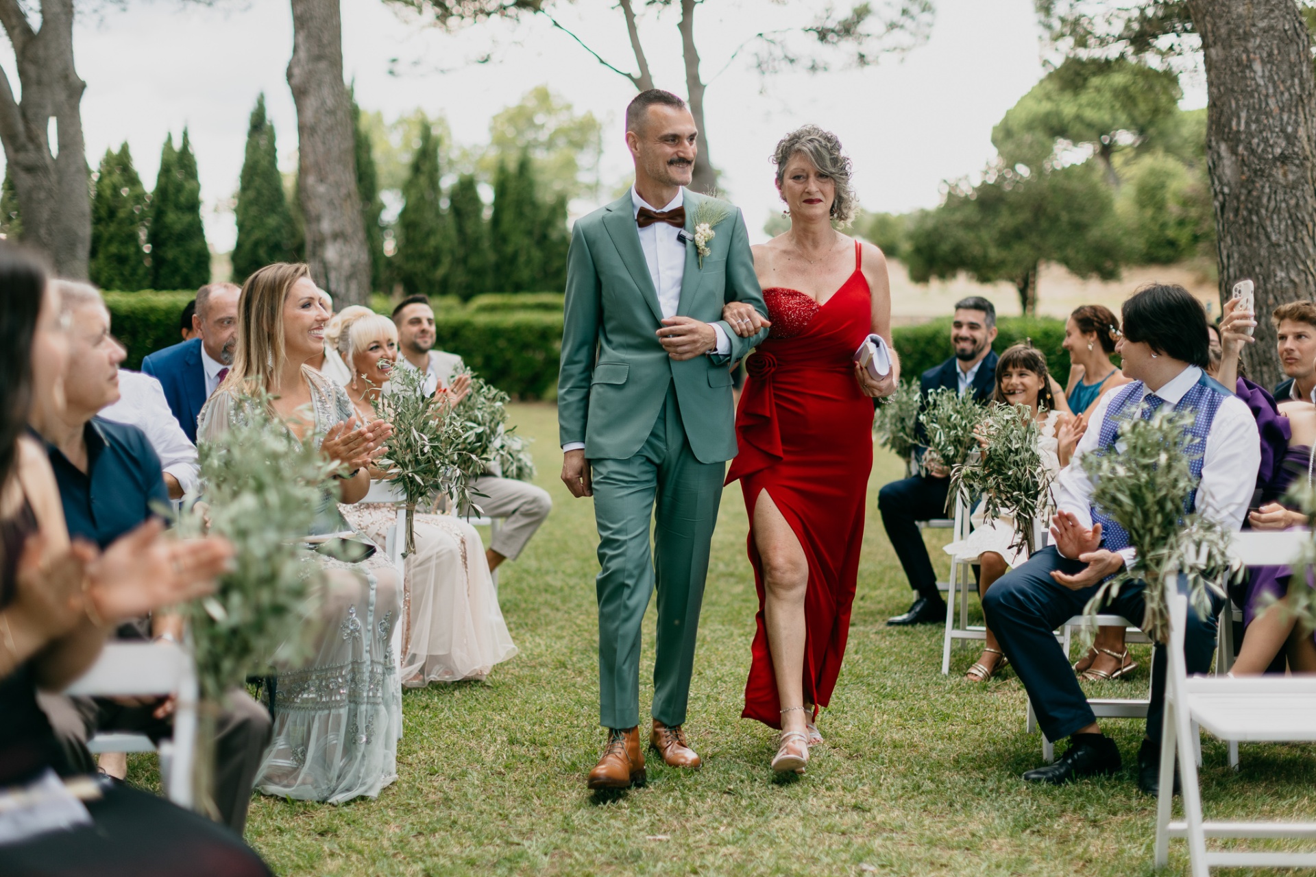 Groom walking down the aisle with his mother at Mas Terrats