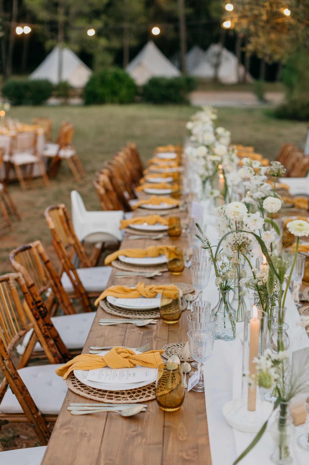 Long table setup with tipi tents at Mas Terrats