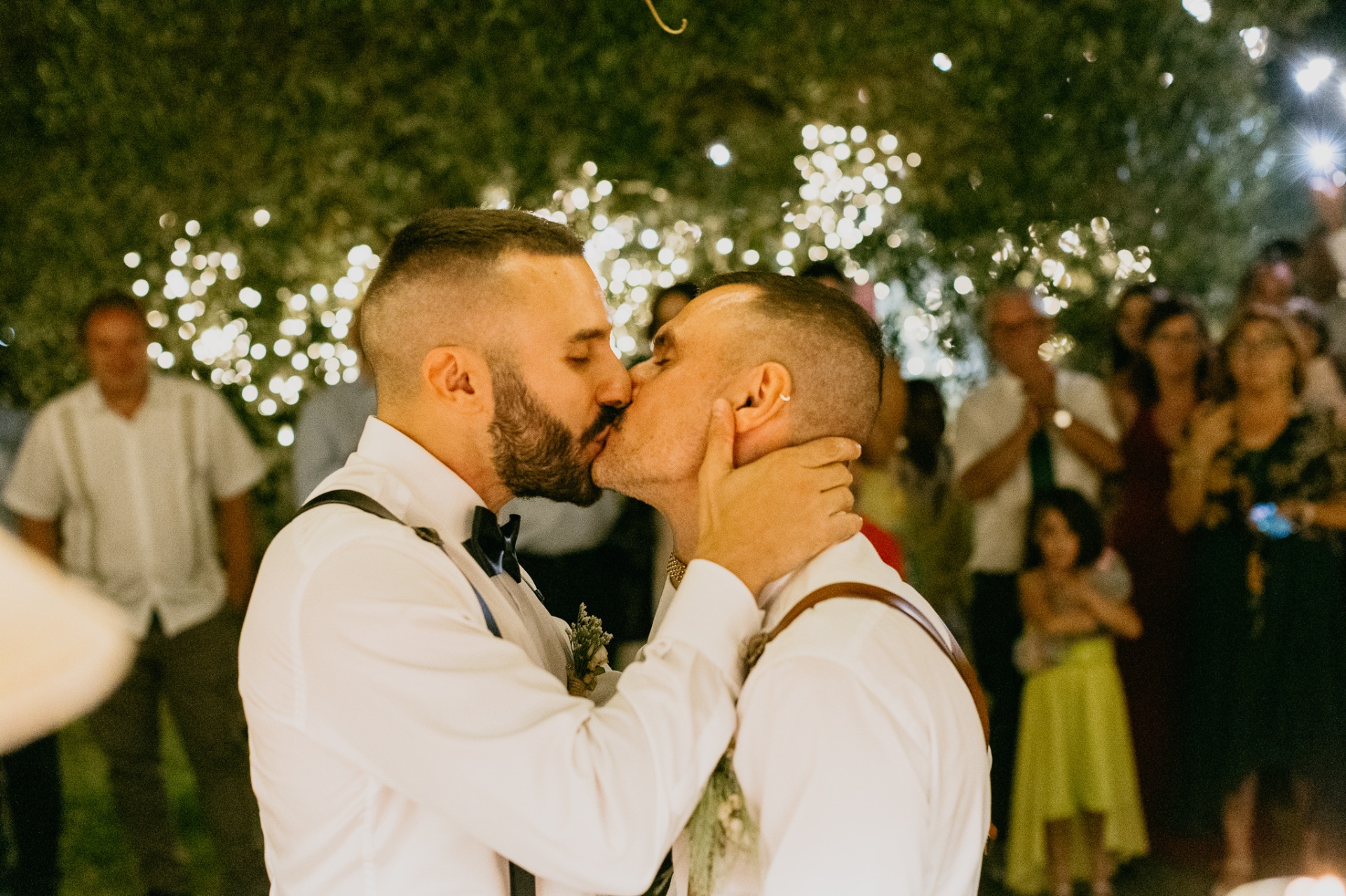 Passionate kiss under the fairy lights