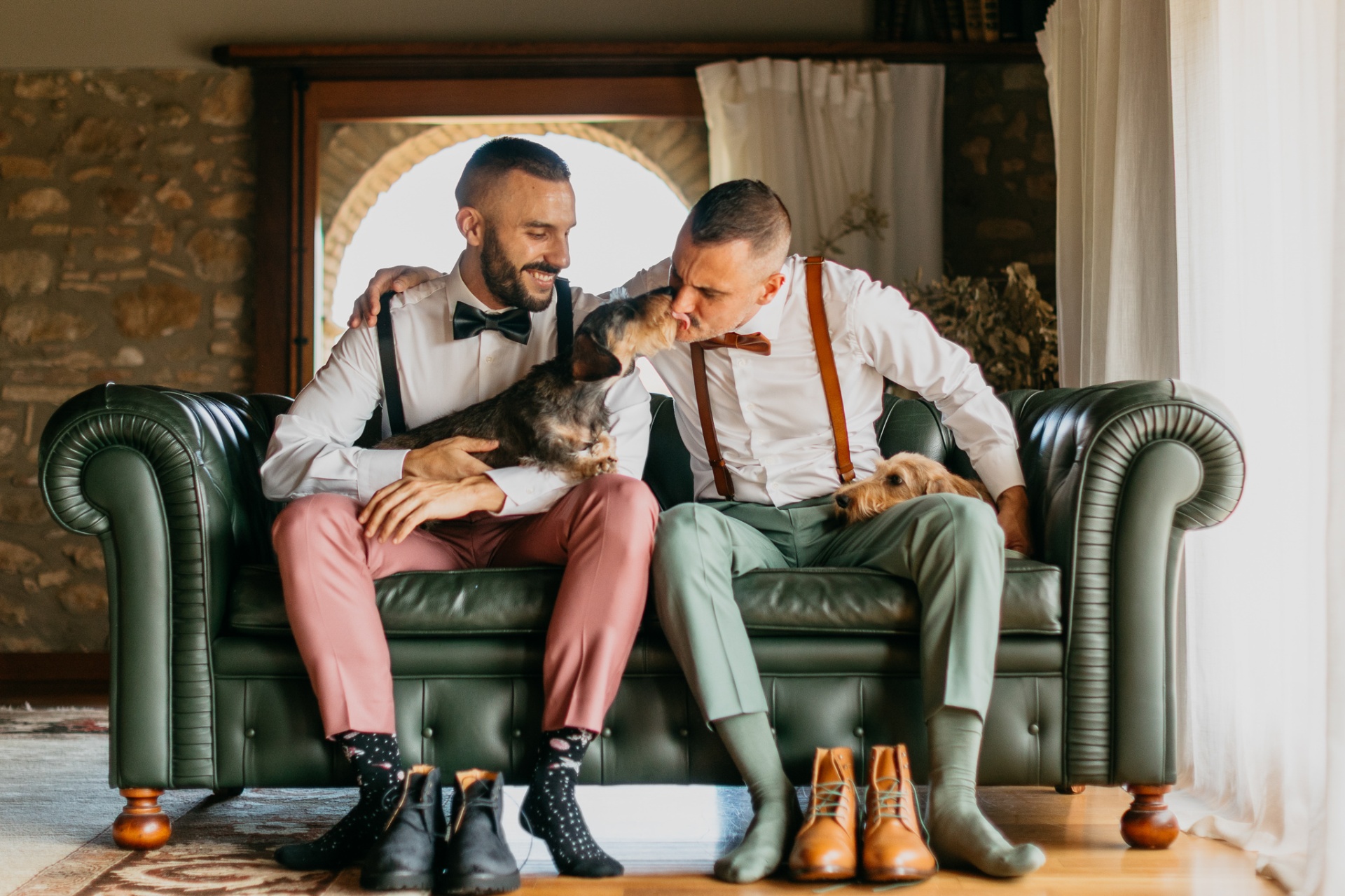 Robert and Edgar with their dogs on the sofa